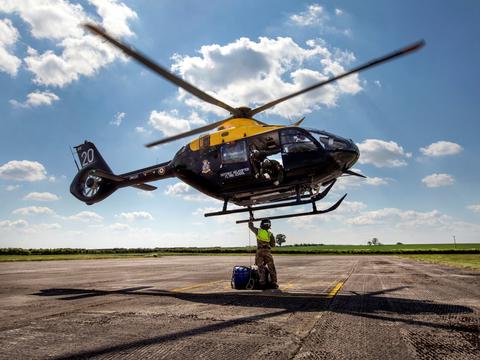 Trainee hooking up an underslung load Trainee hooking up an underslung load on an H145