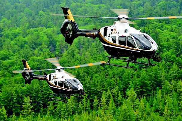 A pair of Airbus H135 helicopters operated by Ontario Provincial Police in Canada fly in formation. 