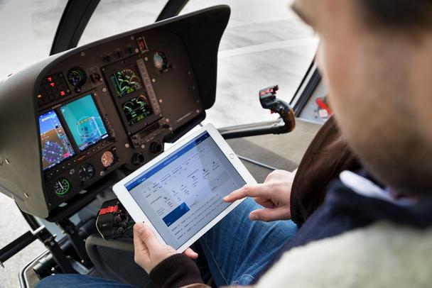 Reviewing Airbus’ helicopter flight data on a tablet device. Reviewing Airbus’ helicopter flight data on a tablet device.