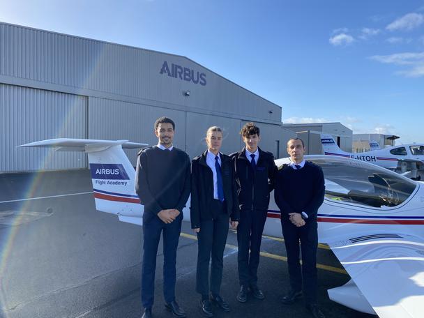 Airbus Flight Academy Cadets with their flight instructor in front of an Elixir Aircraft. Airbus flight academy cadets with flight instructor