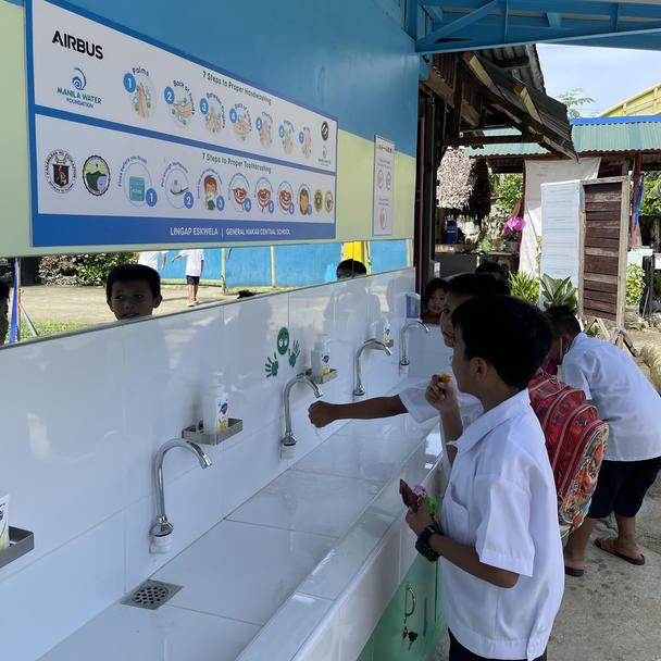 Children using the new hand hygiene facility Children using the new hand hygiene facility