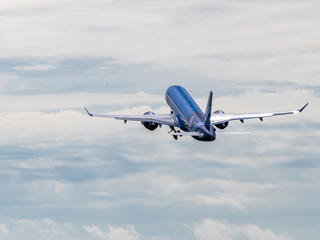 Breeze First A220 in the air