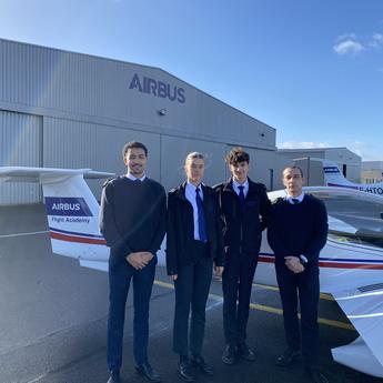 Airbus Flight Academy Cadets with their flight instructor in front of an Elixir Aircraft.
