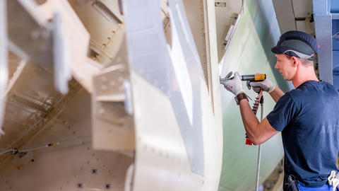 Apprentice operating on aircraft