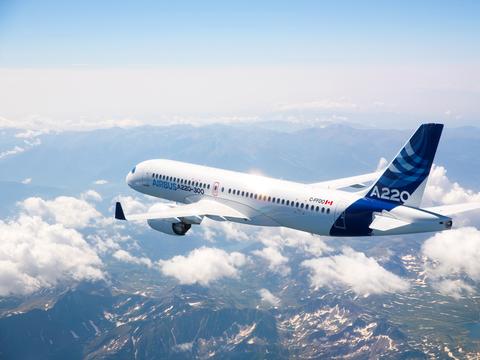 Airbus A220-300 in-flight above mountains