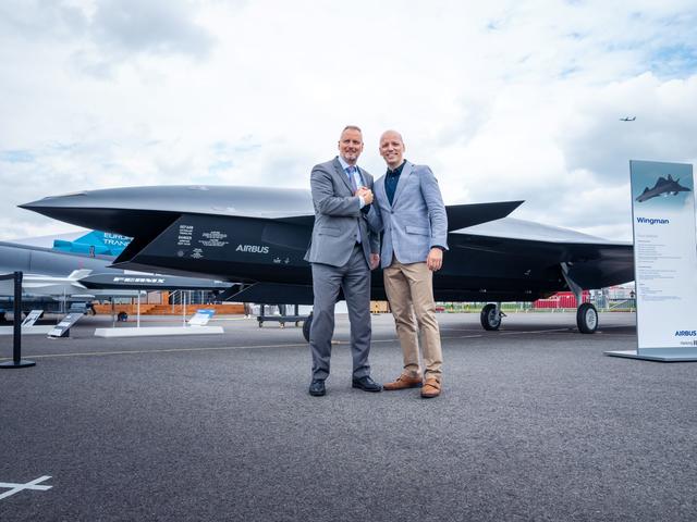 Michael Schoellhorn, CEO at Airbus Defence and Space (on the left), and Gundbert Scherf, Co-CEO at Helsing, in front of the Airbus Wingman model.