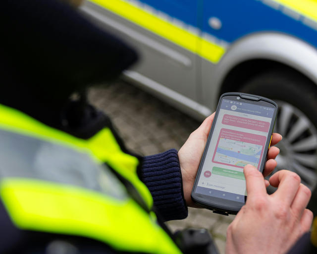 Agnet, a push-to-talk app A policeman with a smartphone using the Agnet push-to-talk app