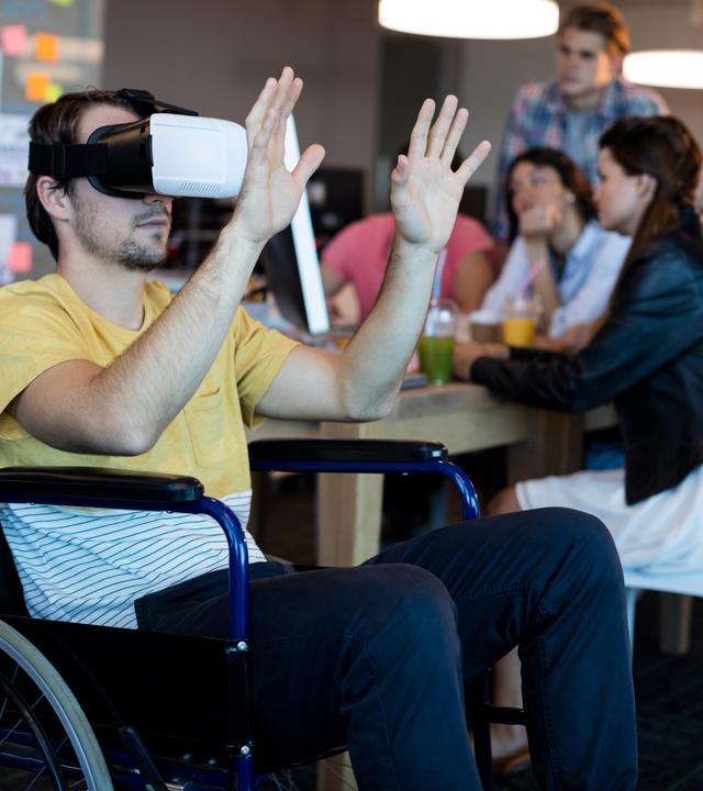 man on wheelchair using VR headset