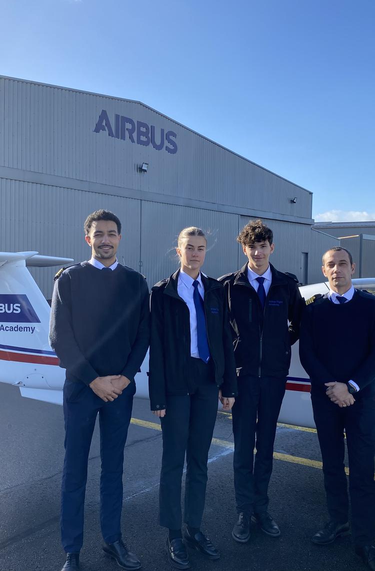 Airbus Flight Academy Cadets with their flight instructor in front of an Elixir Aircraft.