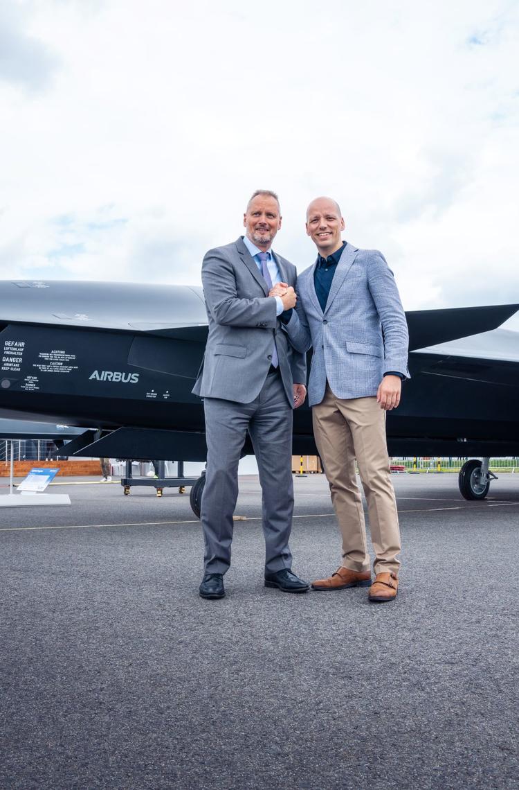Michael Schoellhorn, CEO at Airbus Defence and Space (on the left), and Gundbert Scherf, Co-CEO at Helsing, in front of the Airbus Wingman model.