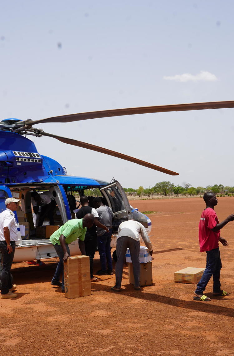 People loading cargo into a helicopter