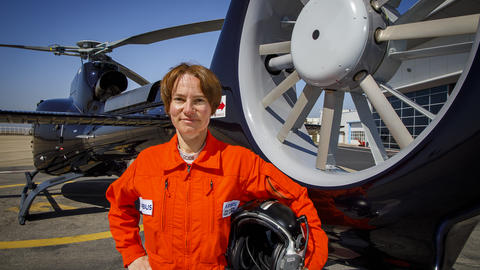 Anne Ducarouge in front of an H130